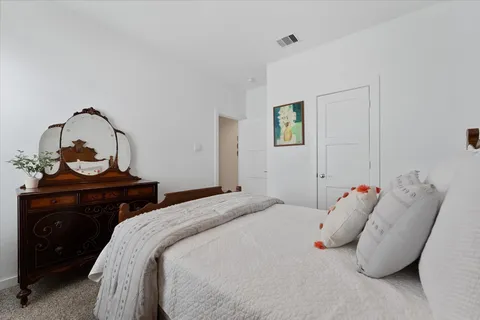 a bedroom with a bed and a dresser