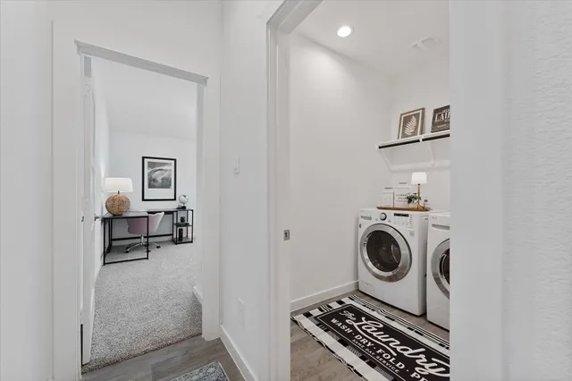 a utility room with sink dryer and washer