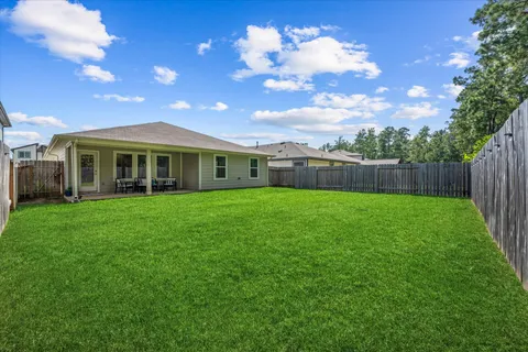 a view of a house with a backyard