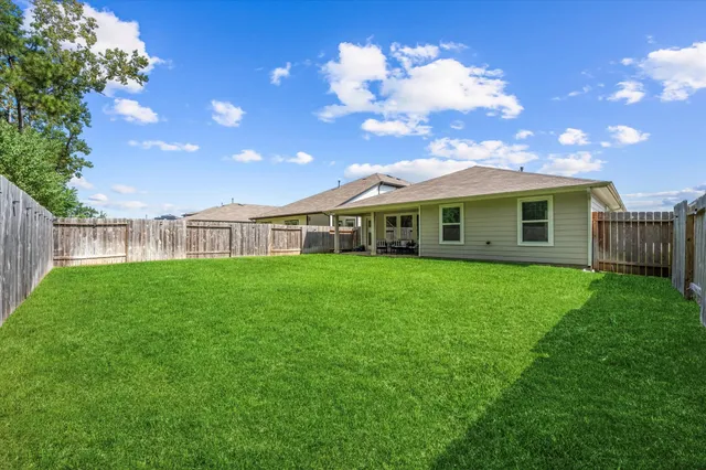 a view of a house with a backyard