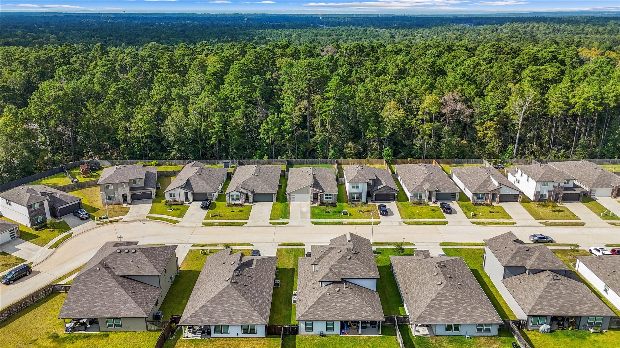 10426 Plateau Pt Trail Conroe, TX 77384 - Photo 41 of 50 an aerial view of residential houses with outdoor space and swimming pool