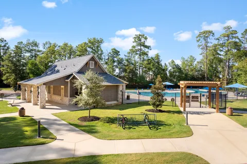 a swimming pool view with a seating space and a garden view