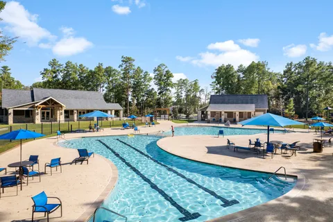 a swimming pool with outdoor seating and yard