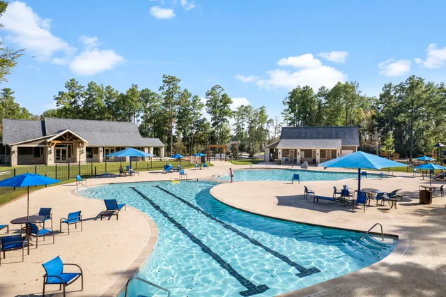 a swimming pool with outdoor seating and yard