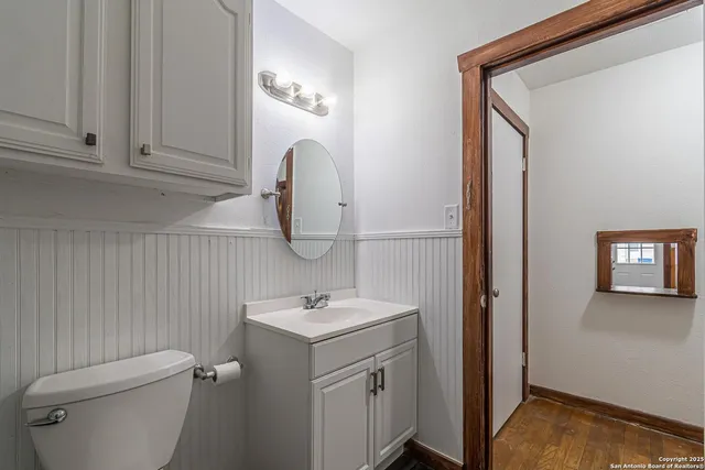 a bathroom with a sink a toilet and mirror