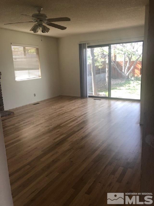 1875 Windsor Way Reno, NV 89503 - Photo 5 of 6 an empty room with wooden floor and windows