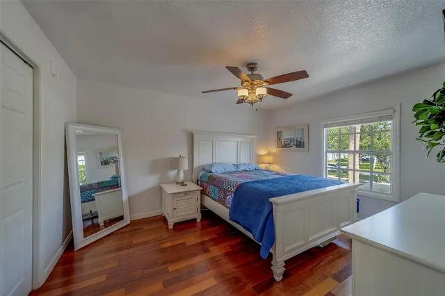 a bedroom with a large bed and a window