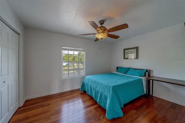 a bed sitting in a bedroom next to a window