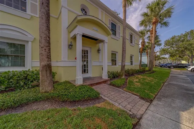 front view of a brick house with a yard