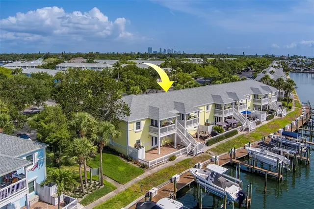 an aerial view of residential houses with outdoor space and swimming pool
