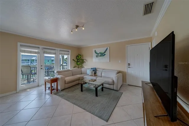 a living room with furniture rug and a flat screen tv