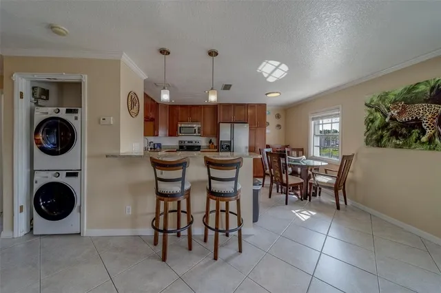 a view of a dining room with furniture and chandelier