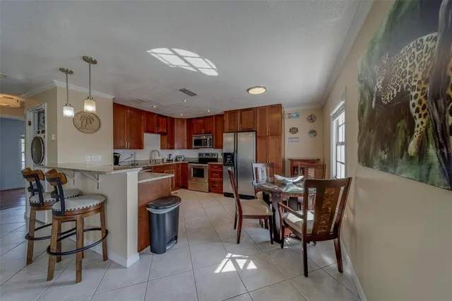 a kitchen with a dining table chairs and a view of kitchen