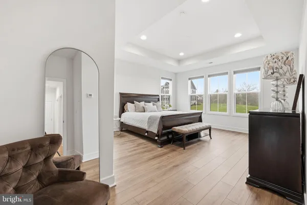 a bedroom with furniture and a large window