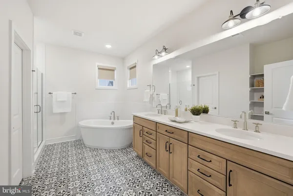 a bathroom with a sink double vanity granite tub and shower