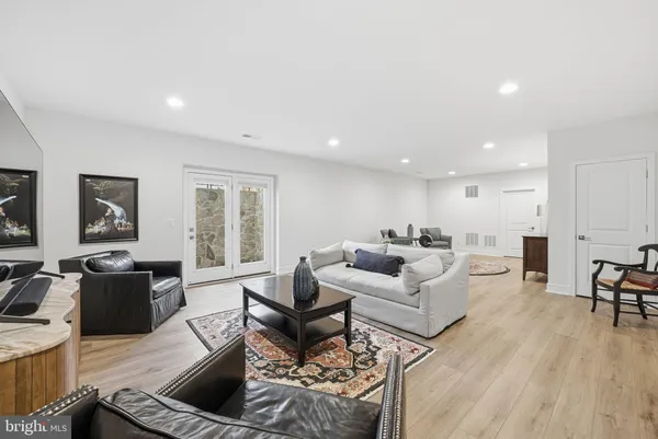 a living room with furniture or couch and a wooden floor