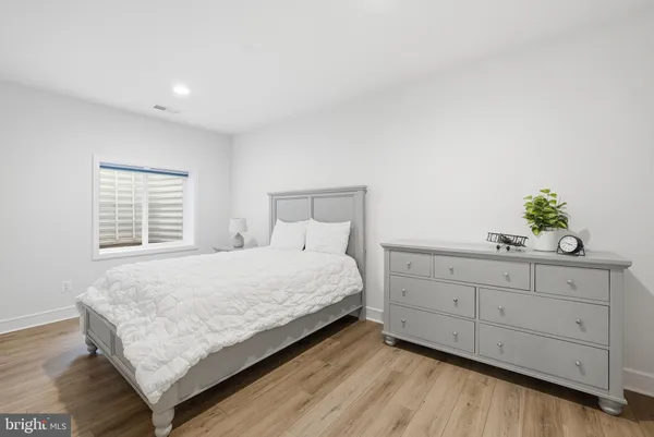 a bedroom with a bed and a dresser