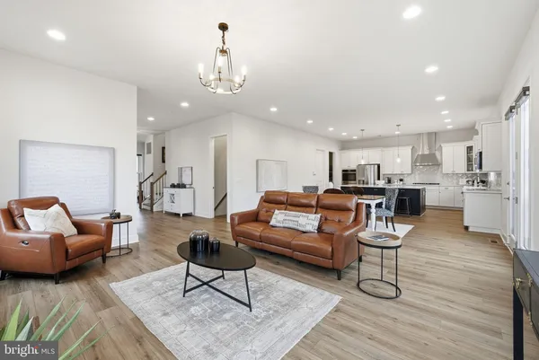 a living room with furniture and kitchen view