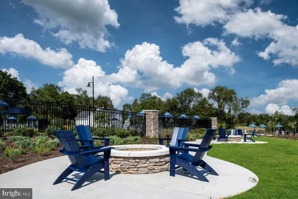 a swimming pool with outdoor seating and garden