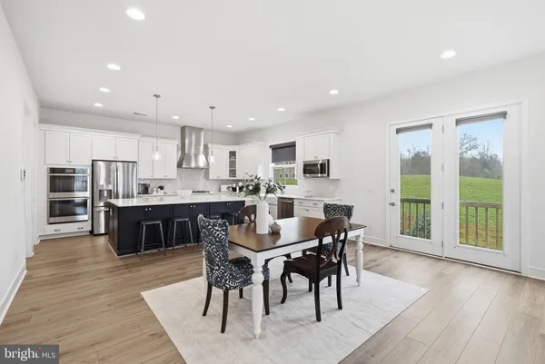a view of kitchen with dining table chairs dining table and stainless steel appliances