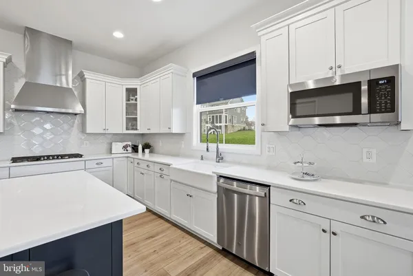 a kitchen with a sink stove and microwave