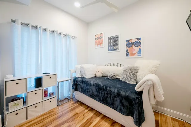 a bed room with a bed and a book shelf