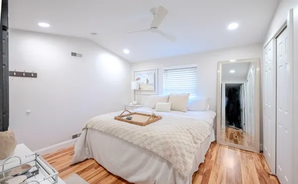 a bedroom with a bed and wooden floor