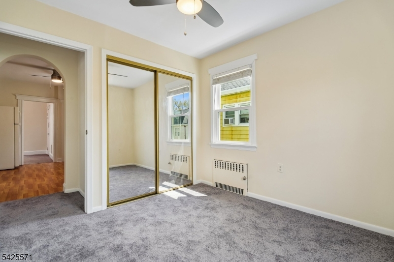 7 Beekman Street, Unit 2 Bloomfield, NJ 07003 - Photo 17 of 27 an empty room with windows and closet