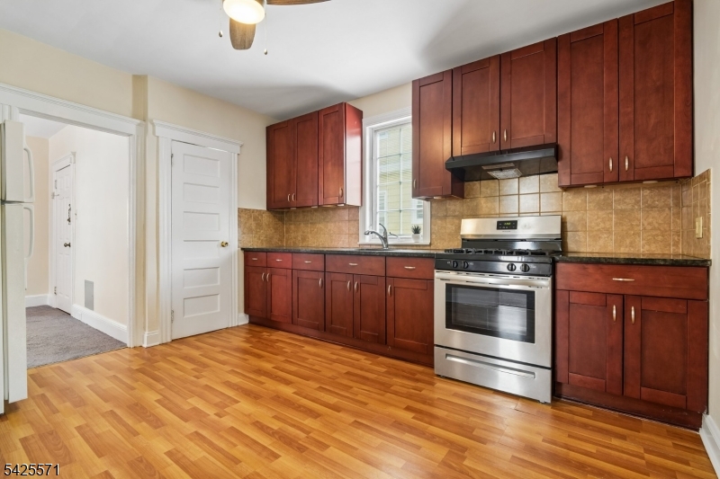 7 Beekman Street, Unit 2 Bloomfield, NJ 07003 - Photo 18 of 27 a kitchen with stainless steel appliances granite countertop a stove cabinets and refrigerator