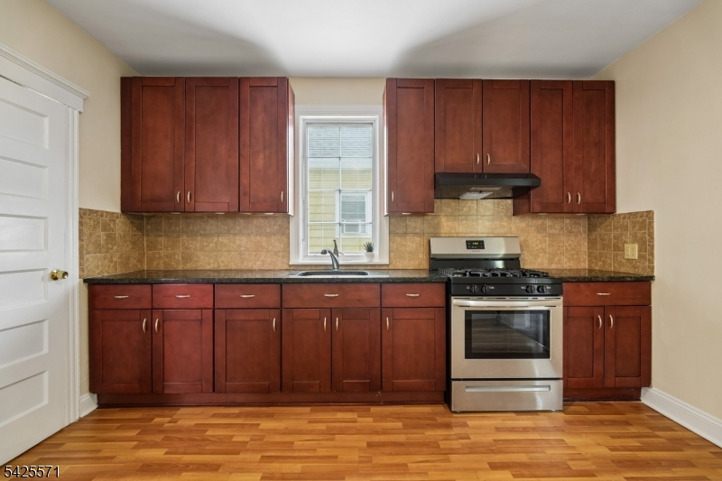 7 Beekman Street, Unit 2 Bloomfield, NJ 07003 - Photo 20 of 27 a kitchen with stainless steel appliances granite countertop a stove a sink and a microwave