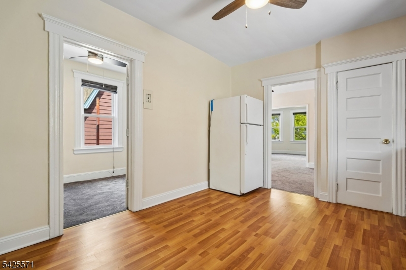 7 Beekman Street, Unit 2 Bloomfield, NJ 07003 - Photo 21 of 27 an empty room with wooden floor cabinet and windows