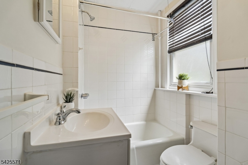 7 Beekman Street, Unit 2 Bloomfield, NJ 07003 - Photo 25 of 27 a bathroom with a sink toilet and shower