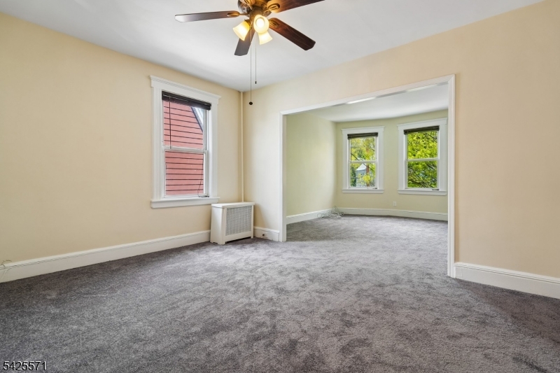 7 Beekman Street, Unit 2 Bloomfield, NJ 07003 - Photo 5 of 27 an empty room with windows and fan