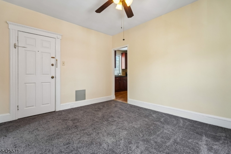7 Beekman Street, Unit 2 Bloomfield, NJ 07003 - Photo 7 of 27 an empty room with ceiling fan and window