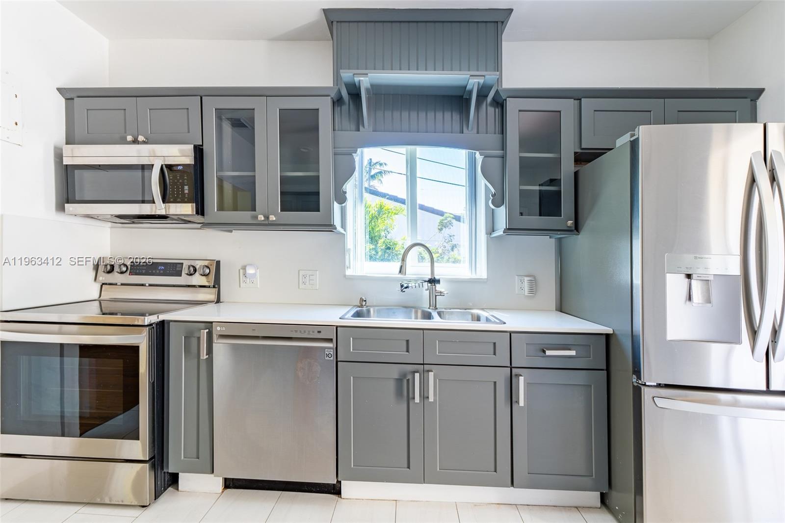 630 Southwest 25th Road Miami, FL 33129 - Photo 11 of 35 a kitchen with stainless steel appliances granite countertop a refrigerator and a sink