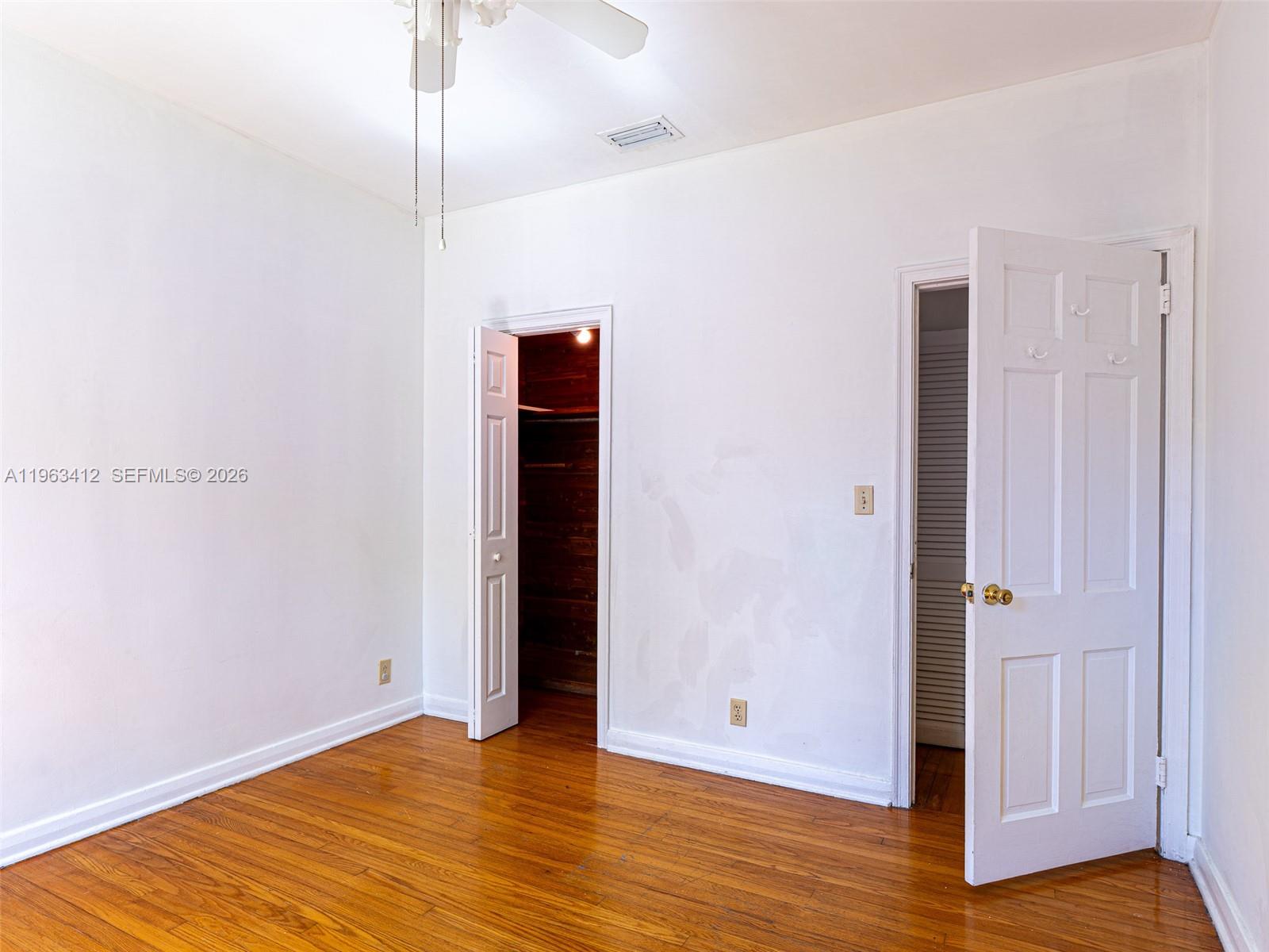 630 Southwest 25th Road Miami, FL 33129 - Photo 20 of 35 a view of an empty room with wooden floor