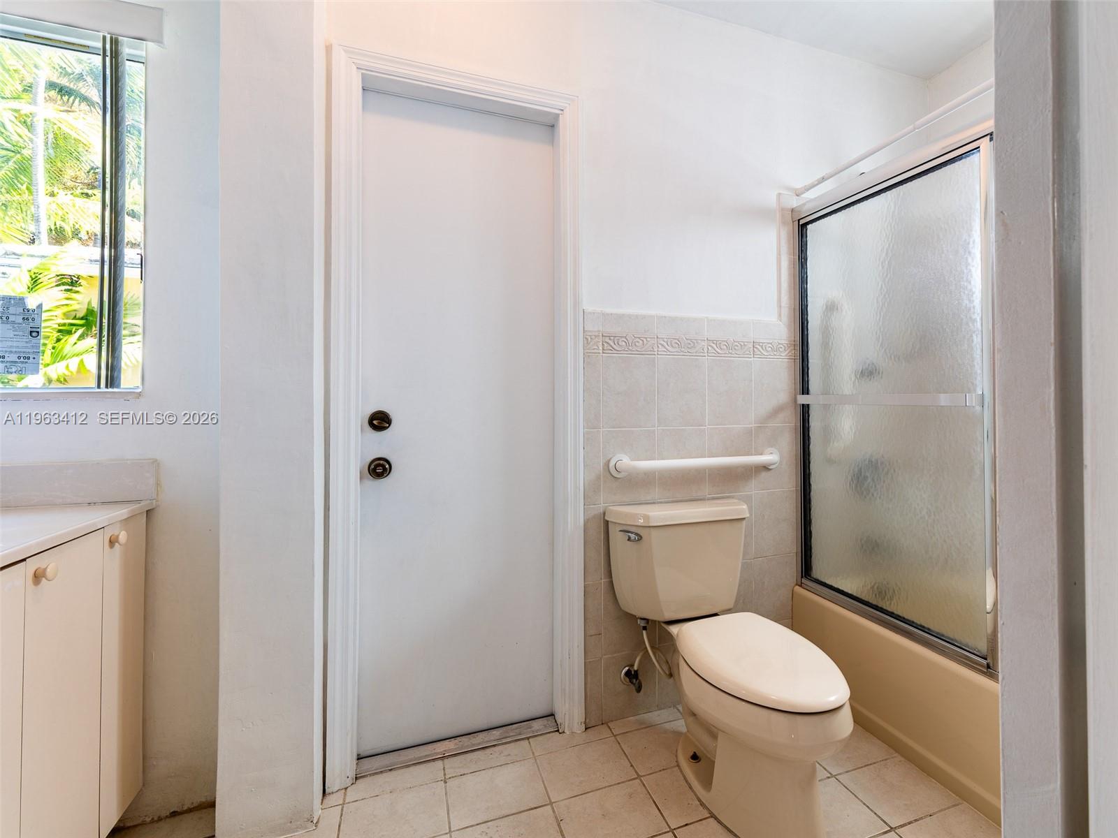 630 Southwest 25th Road Miami, FL 33129 - Photo 25 of 35 a white toilet sitting next to a bathroom sink and a shower