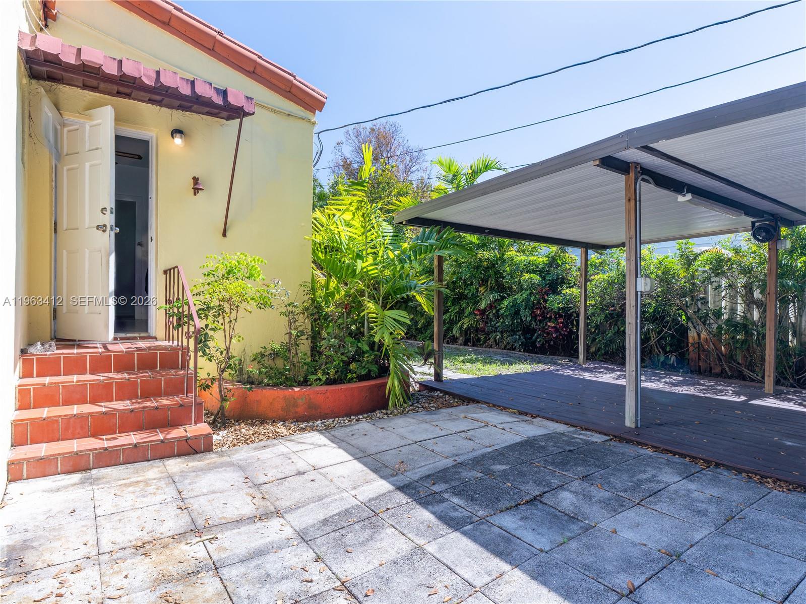 630 Southwest 25th Road Miami, FL 33129 - Photo 27 of 35 a view of a patio with table and chairs under an umbrella