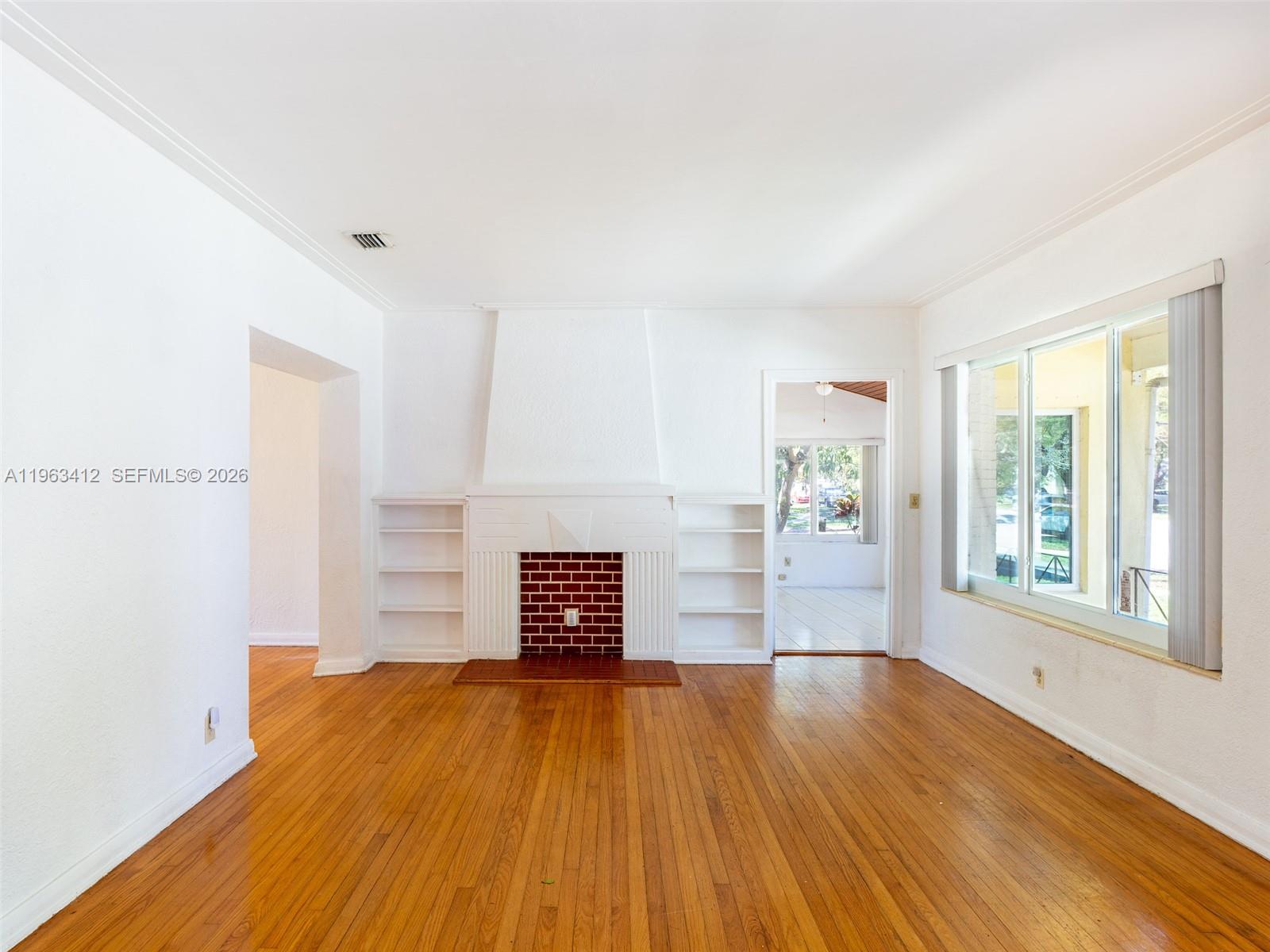 630 Southwest 25th Road Miami, FL 33129 - Photo 5 of 35 a view of empty room with wooden floor