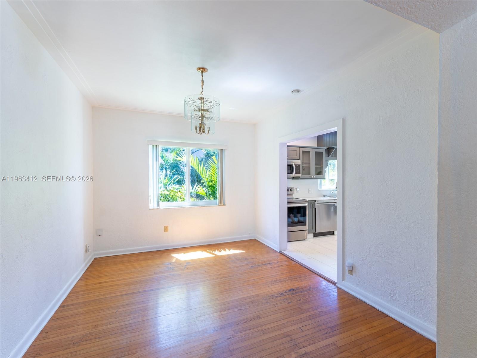 630 Southwest 25th Road Miami, FL 33129 - Photo 7 of 35 a view of a room with wooden floor fireplace and window