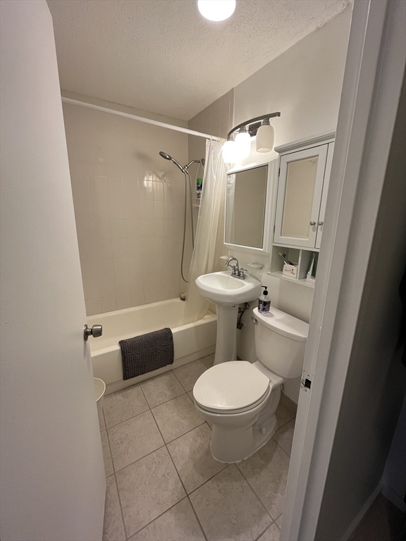 44 Washington Street, Unit 606 Brookline, MA 02445 - Photo 4 of 21 a bathroom with a toilet and a mirror