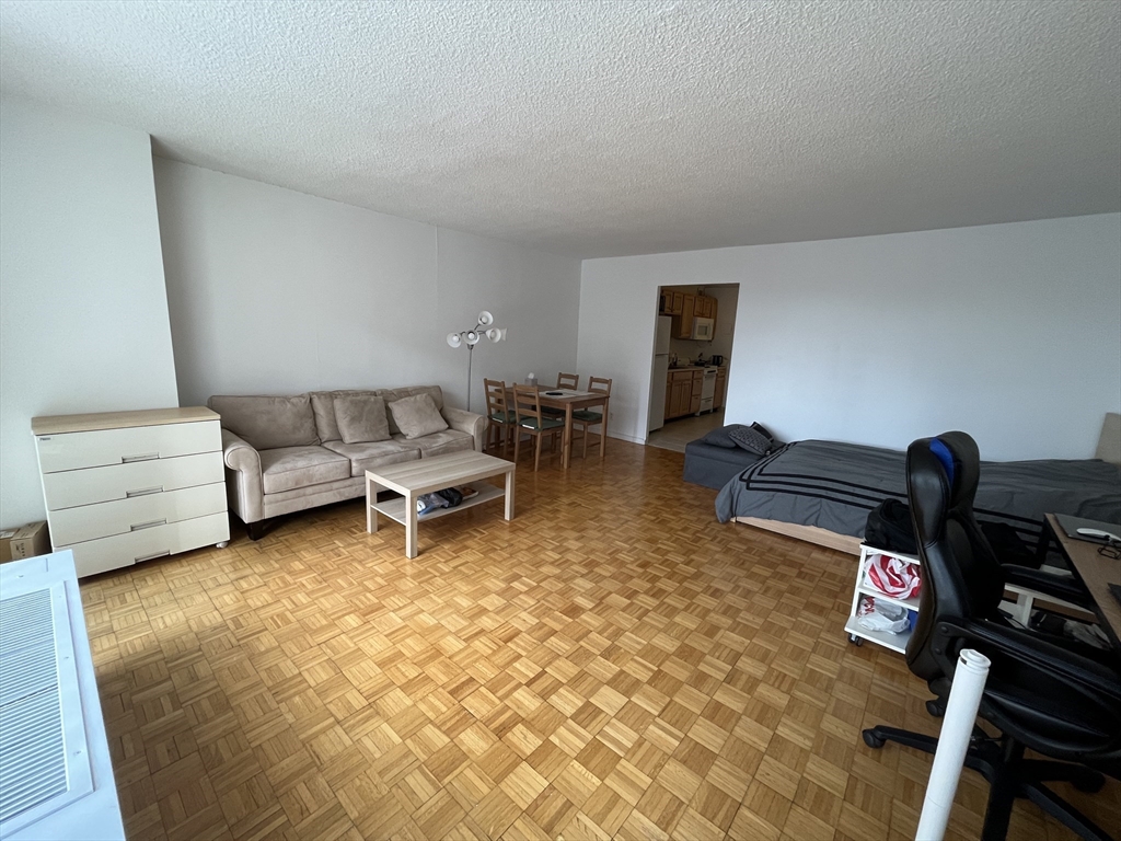 44 Washington Street, Unit 606 Brookline, MA 02445 - Photo 6 of 21 a living room with furniture and a window