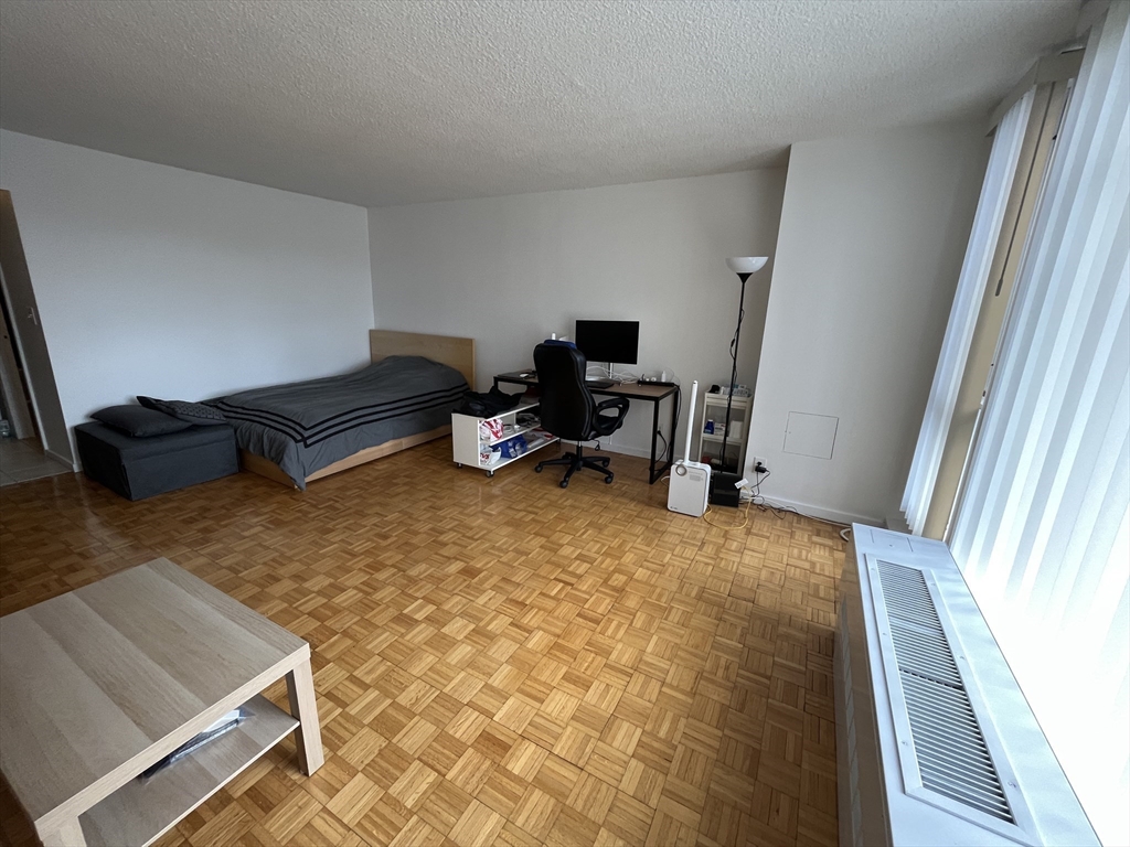 44 Washington Street, Unit 606 Brookline, MA 02445 - Photo 7 of 21 a living room with furniture and a rug