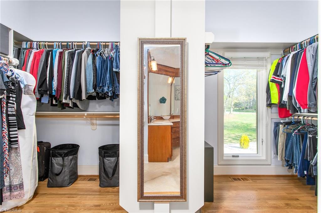 6699 Fegan Road Summerfield, NC 27358 - Photo 21 of 50 Primary closet with wood shelving - all closets in home have wood shelving