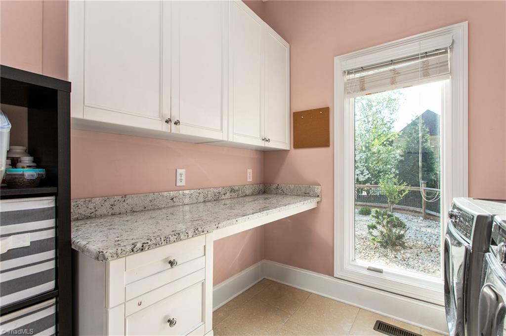 6699 Fegan Road Summerfield, NC 27358 - Photo 23 of 50 Laundry room with dedicated cabinets