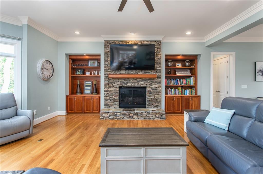 6699 Fegan Road Summerfield, NC 27358 - Photo 7 of 50 Great room with Tennessee Fieldstone fireplace and built in cabinets
