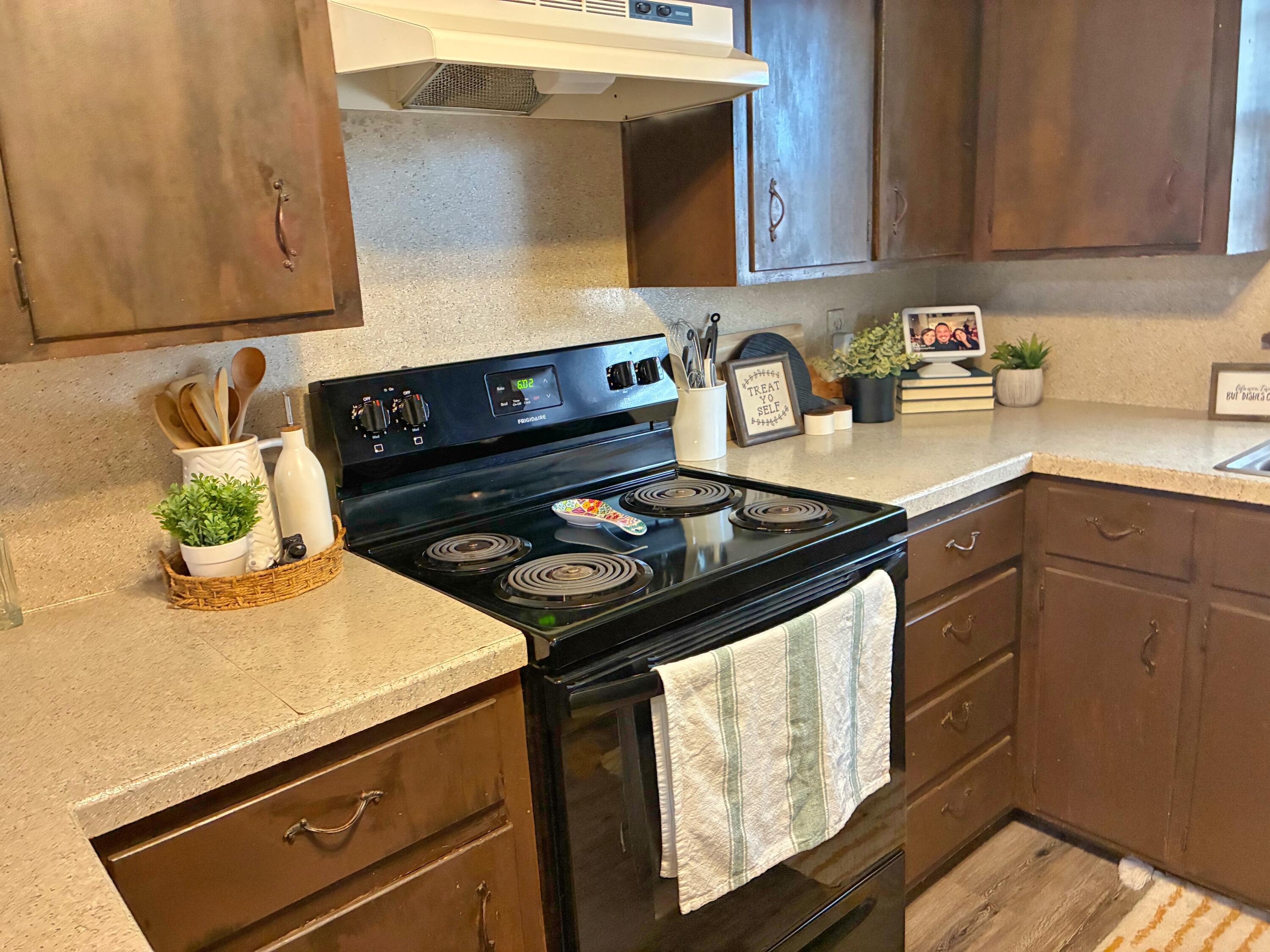 4203 17th Street Lubbock, TX 79416 - Photo 7 of 15 a kitchen with a stove and a sink