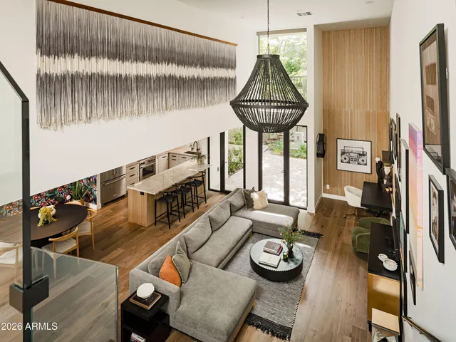 a living room with furniture and a chandelier