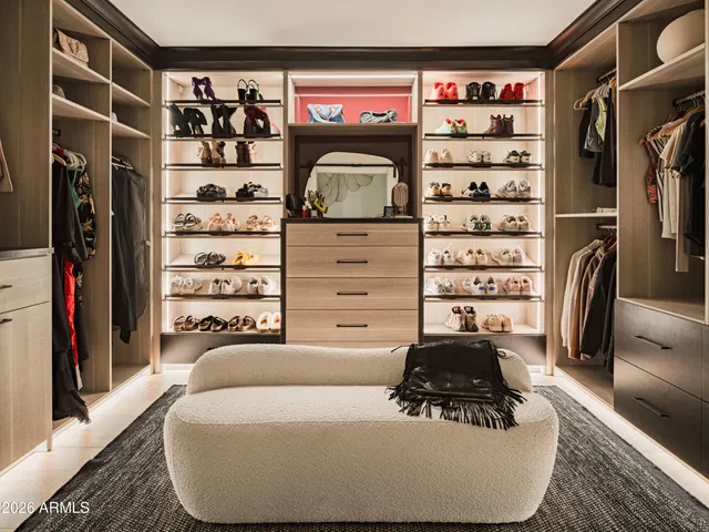 a living room with a couch and a walk in closet