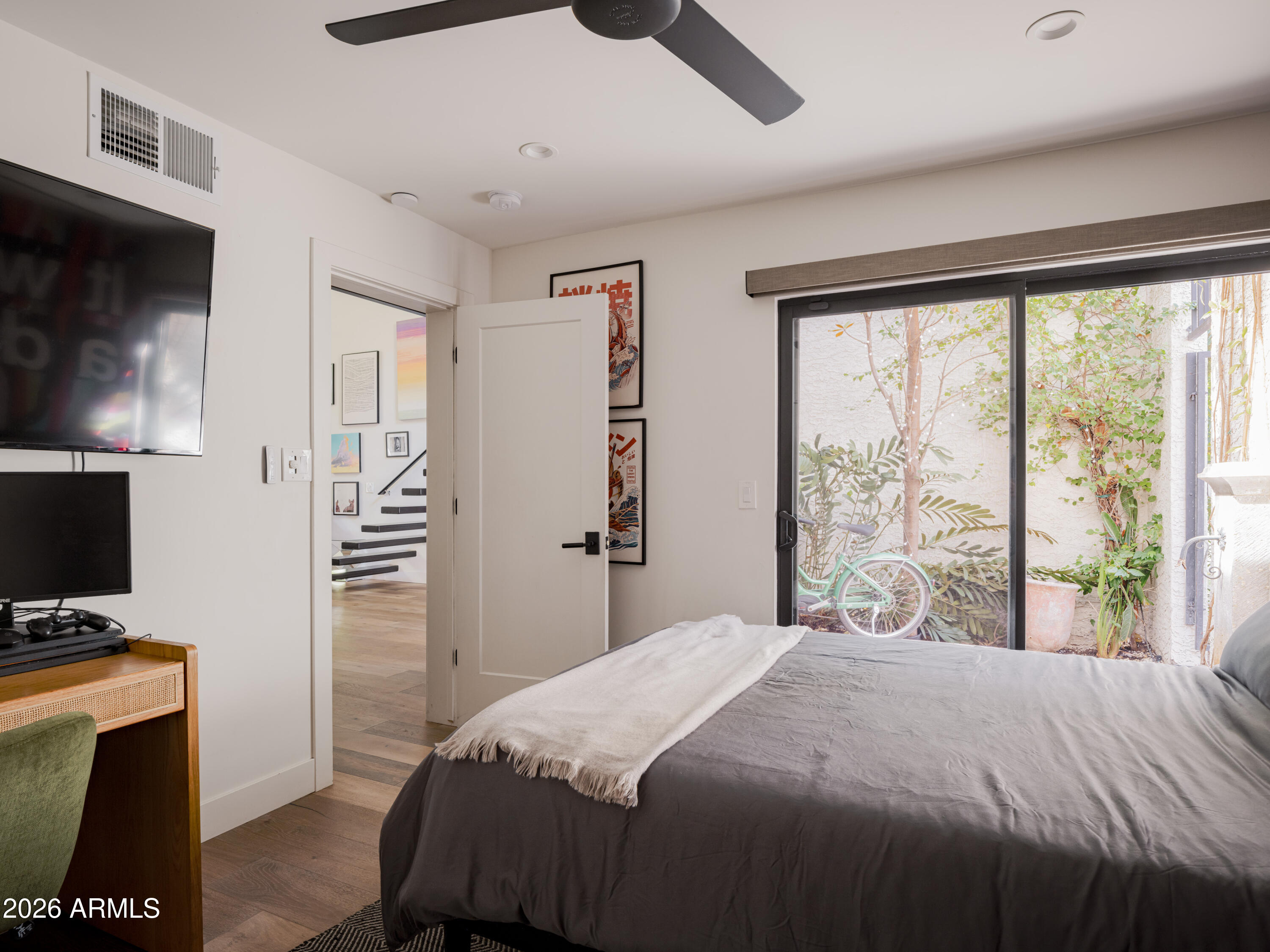 4620 North 40th Street Phoenix, AZ 85018 - Photo 16 of 26 a bedroom with a bed and a flat tv screen